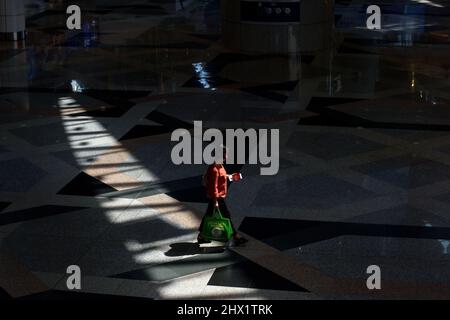 Kuala Lumpur, Malaysia. 9th Mar, 2022. A passenger walks at the Kuala Lumpur International Airport in Sepang of Selangor, Malaysia, March 9, 2022. Malaysia will start the transition to an endemic phase of the pandemic and reopen its borders to international travelers from April 1, Malaysian Prime Minister Ismail Sabri Yaakob said on Tuesday. Credit: Chong Voon Chung/Xinhua/Alamy Live News Stock Photo