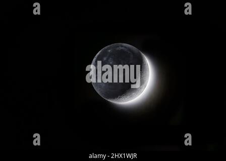 Waxing crescent and earthshine on the darker side of the Moon, Northern Hemisphere, Switzerland Stock Photo