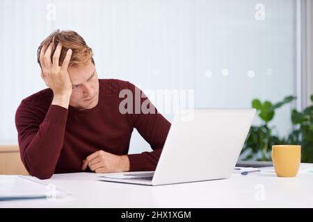 Tired of work. A handsome businessman working at his desk. Stock Photo
