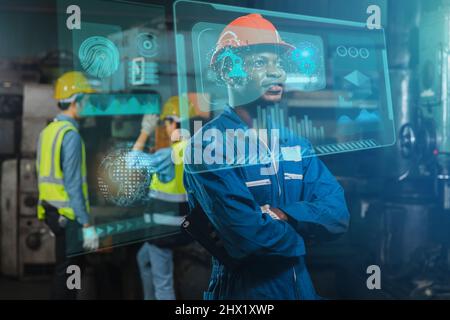 technology industrial African worker, electrical engineer looking and check on high techno screen monitor computer and machinery working in industry, Stock Photo