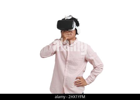 Young peruvian man amazed wearing virtual reality headset, isolated. Stock Photo