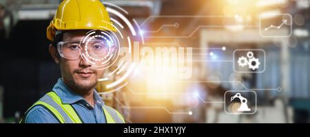 Industrial technology and learning machine software concept, man engineer wearing yellow helmet and protect glasses  with high technology line digital Stock Photo