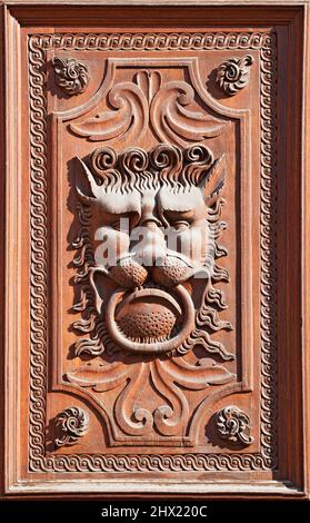Lion head door knocker on an ornated door Stock Photo