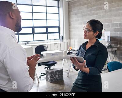 Collaborating on a new project. Shot of colleagues having a discussion at the office. Stock Photo