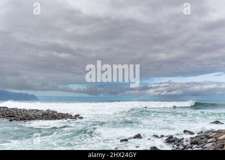 Dramatic morning lights on the beach with fishing pier Stock Photo