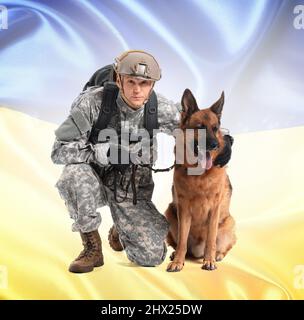 Ukrainian soldier with German shepherd dog near wall outdoors, closeup ...