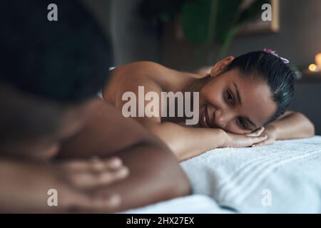 We all deserve a break. Shot of a young couple relaxing on massage beds at a spa. Stock Photo