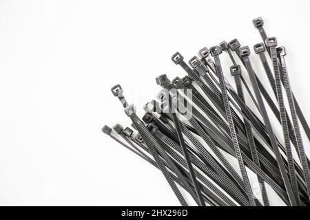 Black cable tie on the white background, high angle view Stock Photo