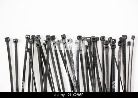 Black cable tie on the white background, high angle view Stock Photo