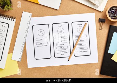 UX design concept. Mobile app wireframe sketches over product designer desk. Top view. Stock Photo
