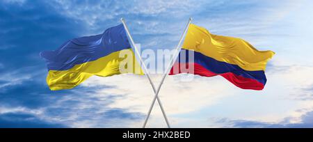 two crossed flags Colombia and Ukraine waving in wind at cloudy sky. Concept of relationship, dialog, travelling between two countries. 3d illustratio Stock Photo