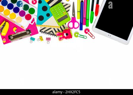 Back to school, education concept Yellow backpack with school supplies Notebook, pens, ruler, calculator, scissors, tablet isolated on white backgroun Stock Photo