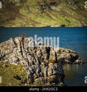 Rocky outcrop and grappling hook on Killary Harbour, Connemara, County Galway, Ireland. Stock Photo