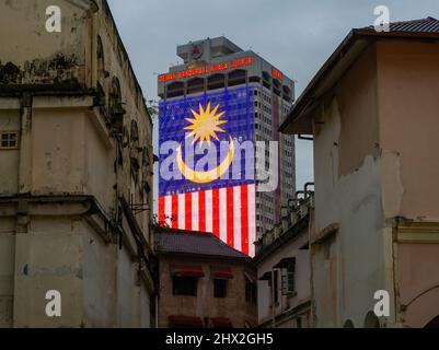 Menara DBKL 1 showing the Malaysian National Flag, taken from a gap between the Old Supreme Court, The FMS Survey Office and the City Theatre Stock Photo