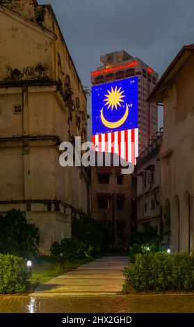 Menara DBKL 1 showing the Malaysian National Flag, taken from a gap between the Old Supreme Court, The FMS Survey Office and the City Theatre Stock Photo