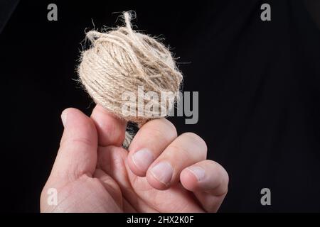 Spool of dark, black thread with needle and one metal thimble on white  background, home crafting, sewing kit, indoors, close-up Stock Photo - Alamy