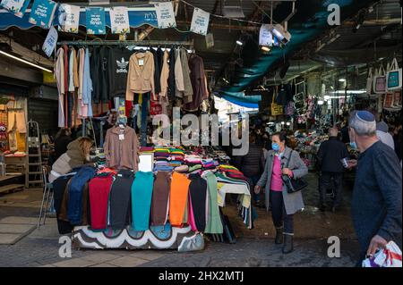 TEL AVIV, ISR - January 25, 2022: Israelis shop at the Carmel Market Shuk HaCarmel in Tel Aviv, Israel. This is a very popular market in Tel Aviv wher Stock Photo