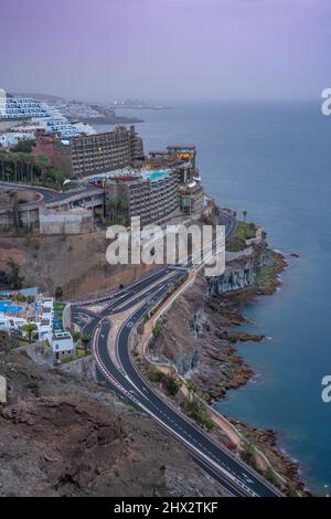 View of coastal road and hotels near Puerto Rico, Playa de Puerto Rico, Gran Canaria, Canary Islands, Spain, Europe Stock Photo