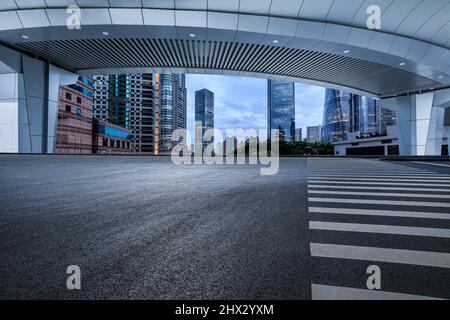 Empty asphalt road and city skyline with modern commercial buildings in Shanghai, China. Stock Photo