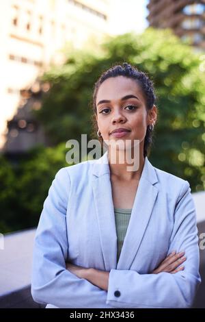 A portrait of a serious young business woman standing on the office balcony Stock Photo