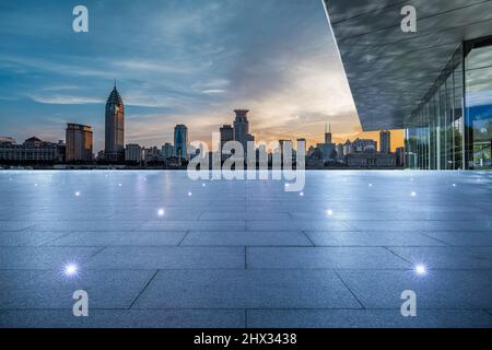 Empty square floor and city skyline with buildings in Shanghai at sunset, China. Stock Photo