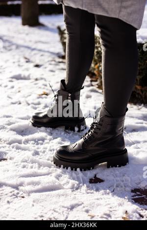 Woman in snow boots and leggings on legs, women's winter shoes Stock Photo  - Alamy