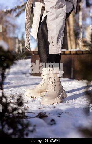 Woman in snow boots and leggings on legs, women's winter shoes Stock Photo  - Alamy