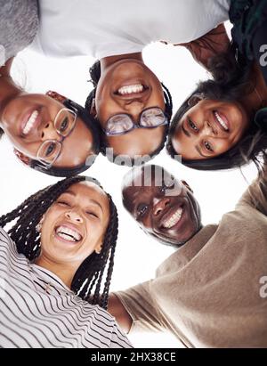 Make your circle bigger. Cropped shot of a group of people looking down at the camera. Stock Photo