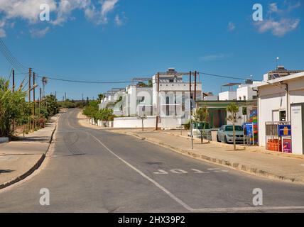 Ayia Napa, Cyprus - May 23, 2021: Typical small street in downtown. Ayia Napa is a tourist resort at the far eastern end of the southern coast of Cypr Stock Photo