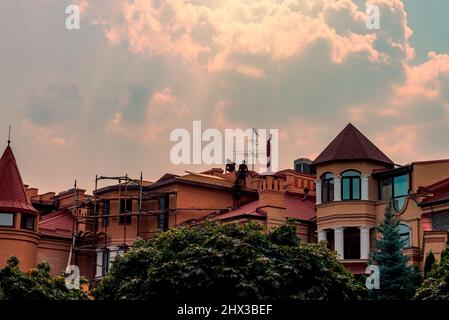 Silhouette of construction workers on the roof of the house. Stock Photo