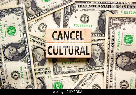 Cancel cultural symbol. Concept words Cancel cultural on wooden blocks on a beautiful background from dollar bills. Business and cancel cultural conce Stock Photo