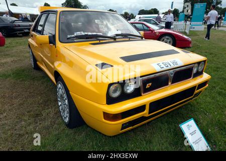 Three-quarters front view of a Yellow, 1992 Lancia Delta HF Integrale Evo 1, on display at the 2021 London Classic Car Show Stock Photo