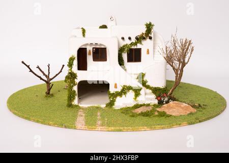 Miniature mediterranean style model house isolated on white background. House development concept. Stock Photo