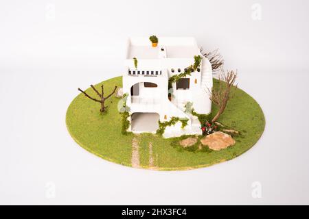 Miniature mediterranean style model house isolated on white background. House development concept. Stock Photo