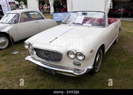Three-quarter Front view of a  White, 1964, Lancia Flavia Cabriolet by Vignale, on display at the 2021 London Classic Car Show Stock Photo