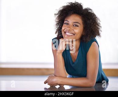 The magic Im going to work in this kitchen.... Portrait of an attractive young woman standing in her kitchen. Stock Photo