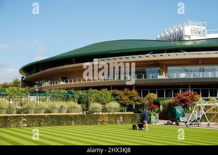 Groundman cuts the grass in front of the No.1 Court at The All England Lawn Tennis Club, home to The Wimbledon Championships Stock Photo