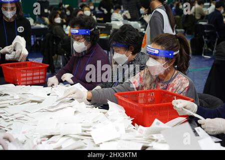 Seoul, South Korea. 9th Mar, 2022. Staff members count ballots for the presidential election at a ballot counting station in Seoul, South Korea, March 9, 2022. Credit: James Lee/Xinhua/Alamy Live News Stock Photo