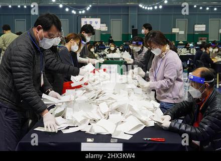 Seoul, South Korea. 9th Mar, 2022. Staff members count ballots for the presidential election at a ballot counting station in Seoul, South Korea, March 9, 2022. Credit: James Lee/Xinhua/Alamy Live News Stock Photo