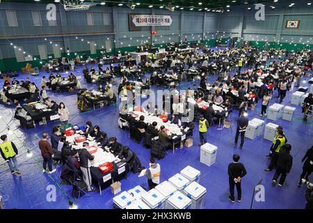 Seoul, South Korea. 9th Mar, 2022. Staff members count ballots for the presidential election at a ballot counting station in Seoul, South Korea, March 9, 2022. Credit: James Lee/Xinhua/Alamy Live News Stock Photo