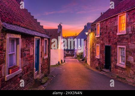 A narrow street leading down to Crail Harbour in the East Neuk of Fife, Scotland, UK Stock Photo
