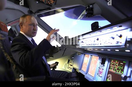 Moscow, Russia. 05 March, 2022. Russian President Vladimir Putin sits in the cockpit of an airplane simulator during a visit to the Aeroflot aviation training complex, March 5, 2022 in Moscow, Russia. Aeroflot is suspending most international flights out of fear of having their aircraft impounded. Stock Photo