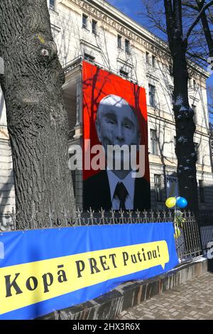 Riga, Latvia. 09th Mar, 2022. A large poster with a portrait of Russian President Vladimir Putin styled as a skull hangs on the façade of the Museum of Medical History in Latvia's capital Riga (inscription on the poster in German: Gemeinsam gegen Putin!) Credit: Alexander Welscher/dpa/Alamy Live News Stock Photo