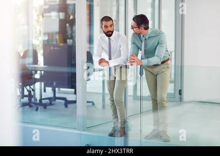 Discussing any issues at work. Shot of colleagues having a discussion in a modern office. Stock Photo