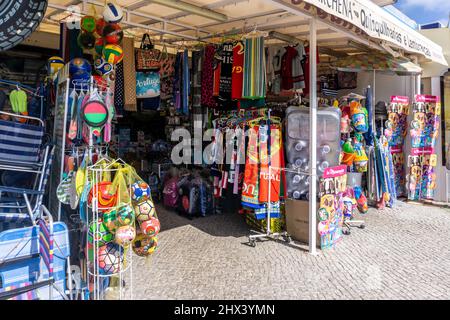 A shop selling everything for a day at the beach including towels, beach balls, beach chairs, air beds etc in Quarteira, Portugal. Stock Photo