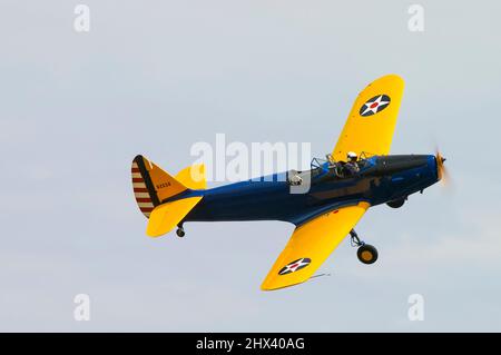 Fairchild PT-19 Cornell plane flying at an airshow. Second World War primary trainer for the United States Army Air Corps with old style wing markings Stock Photo
