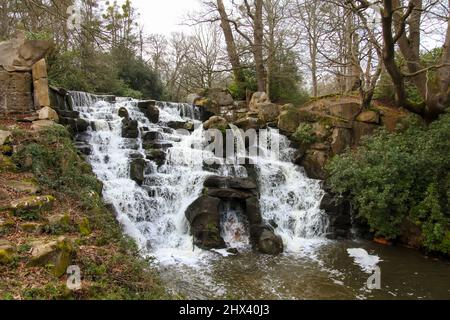 The Cascade waterfall at Virginia Water Lake, Windsor Great Park, Surrey, England, UK, March 2022 Daytime Stock Photo