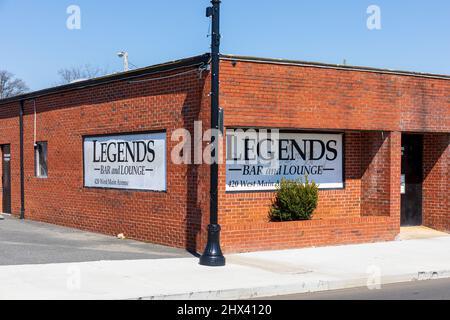 GASTONIA, NC, USA-3 MARCH 2022: The Legends Bar and Lounge on W. Main St.  Close-up view of front left corner, showing painted signs. Stock Photo