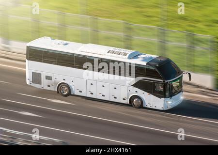 Tourist bus speeding on highway, blured in motion Stock Photo