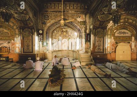 Muslim Sleeping and Praying men inside Mahabat Khan Mosque in Peshawar Stock Photo